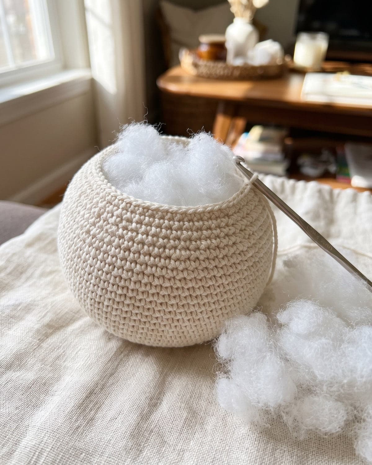 Cream crochet ball with an open top filled with white stuffing