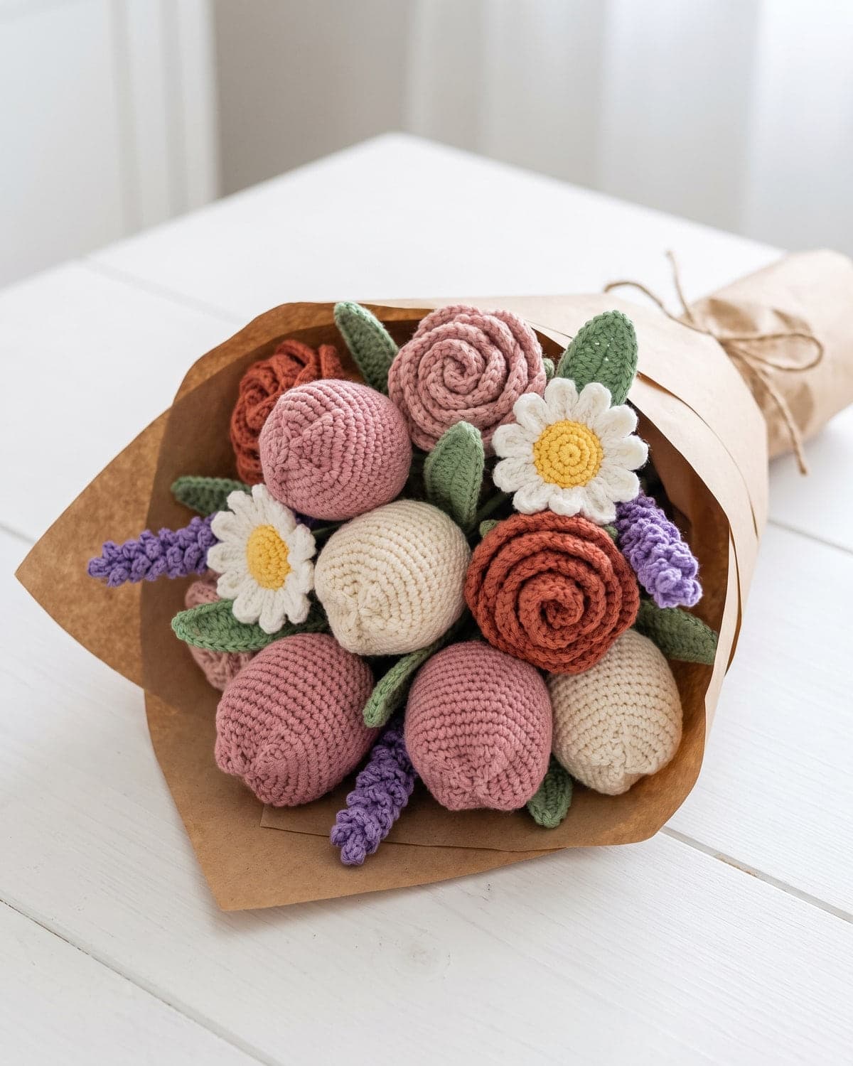 Crochet flower bouquet of tulips, roses, daisies and lavender in pink, cream and terracotta, wrapped in kraft paper